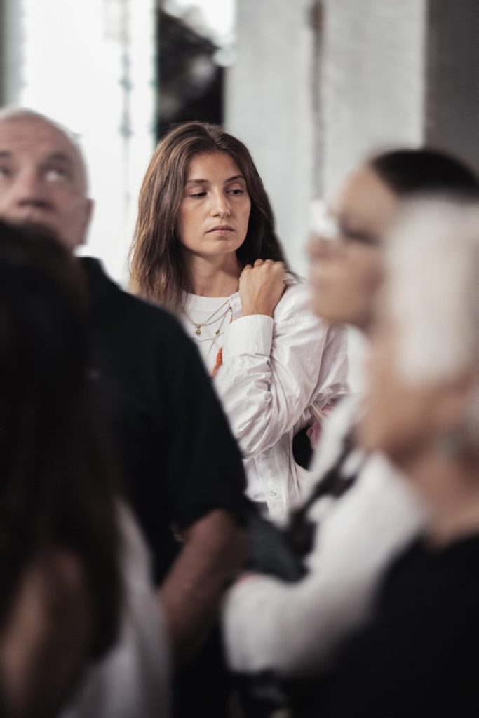 woman standing to the side of a group